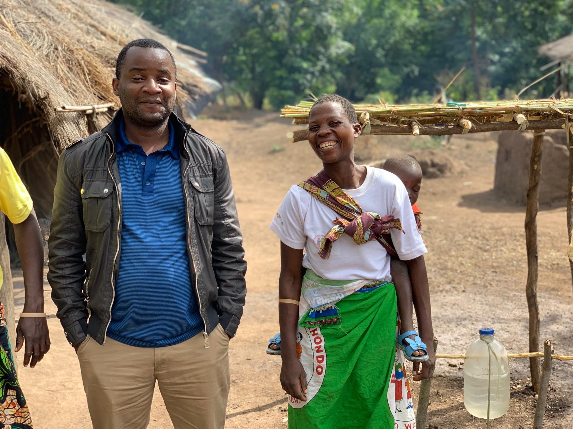 Kondwani and one of the study participants in Chikwawa district. The study participant is wearing a chitenje, t-shirt and wristband given out as part of the Hygienic Family intervention.  